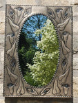 Rectangular tin mirror with lilly design.
